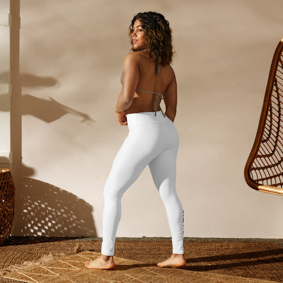 Woman wearing white high-waisted Overtuned Yoga Leggings, showcasing a sleek, seamless fit for flexibility and comfort.